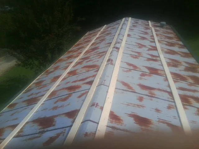 Rusted metal roof panels with new wood purlins before replacement — Storm Damage Roof Repair in Bonham by Roofing Brothers